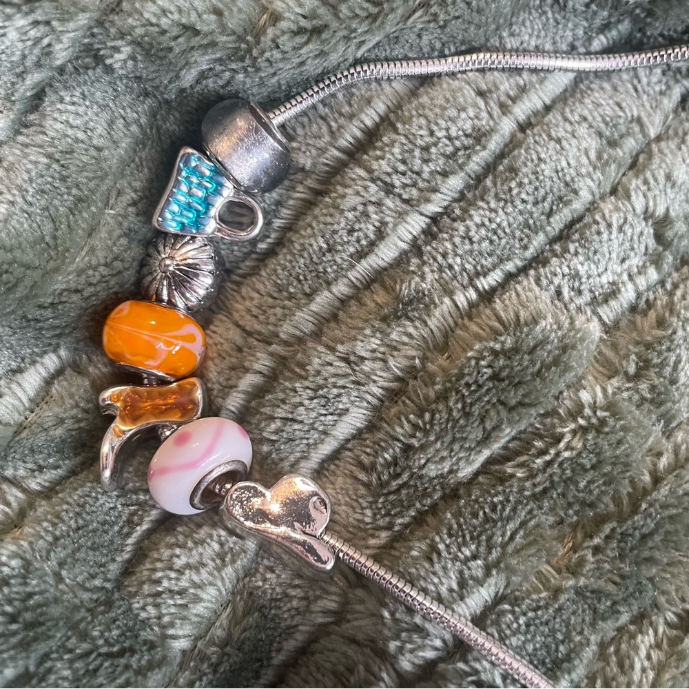 Charm necklace with cowboy hat, cowboy boot, flower, and purse